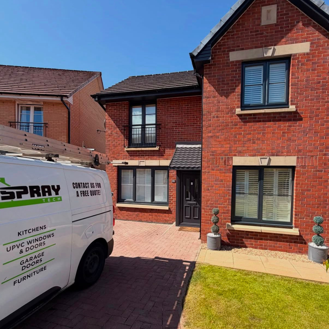 Red brick semi-detached home with resprayed anthracite grey uPVC windows and front door.