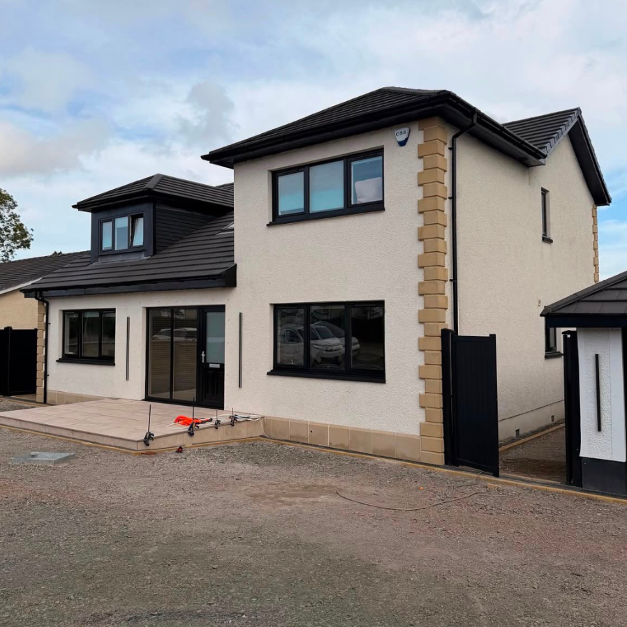 Modern rendered detached home with resprayed black uPVC windows and patio doors.